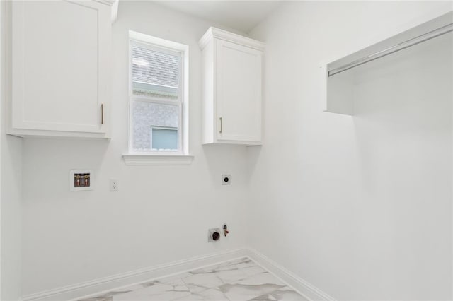 2025 White Dove Dr, Madisonville, LA 70447 - laundry area featuring hookup for an electric dryer, marble look tiles, hookup for a washing machine, and cabinet space