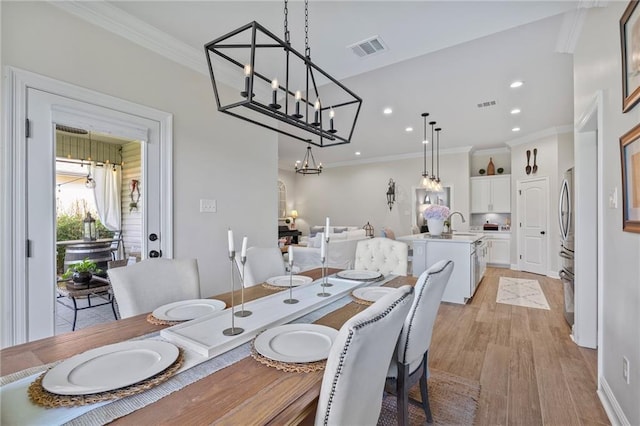 502 Terrace Lake Dr, Covington, LA 70435 - dining area featuring light wood-type flooring, a chandelier, recessed lighting, and crown molding