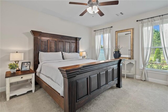 502 Terrace Lake Dr, Covington, LA 70435 - bedroom with multiple windows, light colored carpet, and a ceiling fan