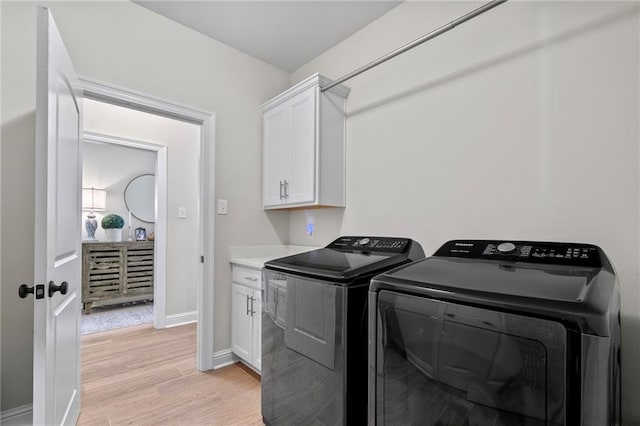 502 Terrace Lake Dr, Covington, LA 70435 - laundry room featuring washer and clothes dryer, cabinet space, and light wood finished floors