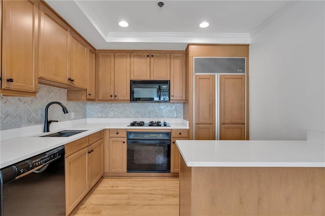 920 Poeyfarre St Unit Ph18, New Orleans, LA 70130 - kitchen with black appliances, crown molding, tasteful backsplash, light countertops, and light wood-style flooring
