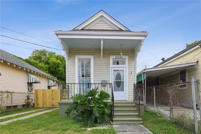 2018 Adams St, New Orleans, LA 70118 - shotgun-style home with a porch and a gate