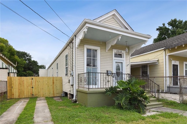 2018 Adams St, New Orleans, LA 70118 - shotgun-style home with a porch
