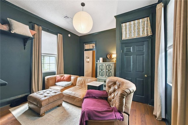 2018 Adams St, New Orleans, LA 70118 - living room with wood finished floors and a textured ceiling