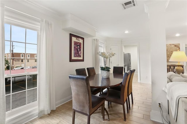 2521 Metairie Lawn Dr Unit 214, Metairie, LA 70002 - dining space with light wood finished floors, crown molding, and recessed lighting