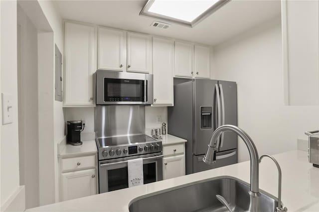 2521 Metairie Lawn Dr Unit 214, Metairie, LA 70002 - kitchen featuring stainless steel appliances, light countertops, and white cabinetry