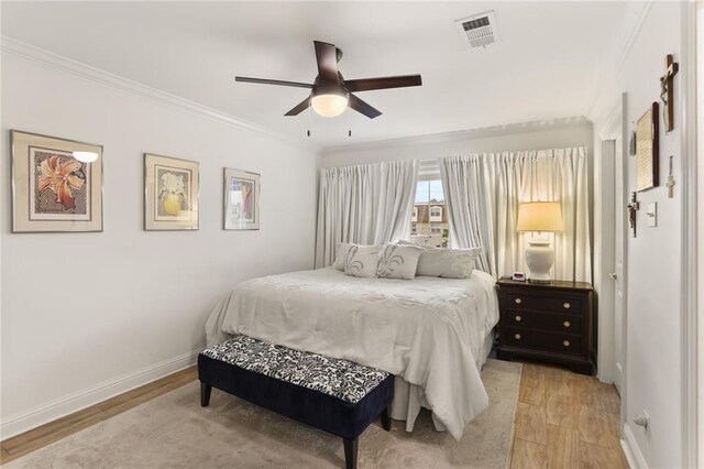 2521 Metairie Lawn Dr Unit 214, Metairie, LA 70002 - bedroom with crown molding, light wood-style flooring, and a ceiling fan
