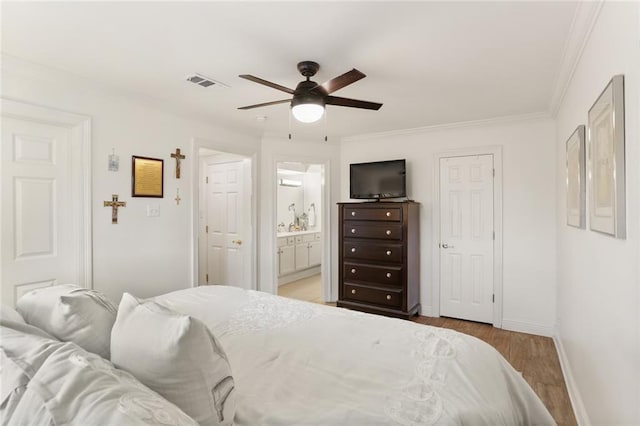 2521 Metairie Lawn Dr Unit 214, Metairie, LA 70002 - bedroom featuring wood finished floors, ornamental molding, ceiling fan, and connected bathroom