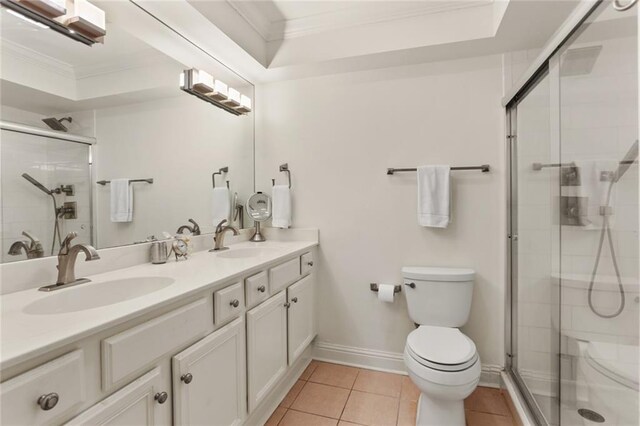 2521 Metairie Lawn Dr Unit 214, Metairie, LA 70002 - bathroom featuring ornamental molding, double vanity, a shower stall, and tile patterned flooring