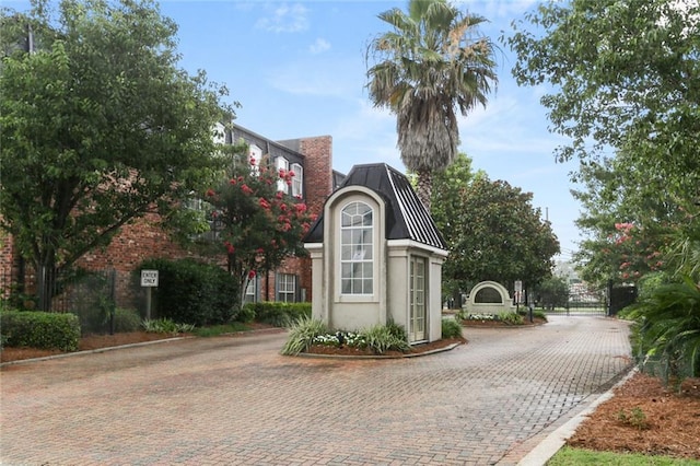 2521 Metairie Lawn Dr Unit 214, Metairie, LA 70002 - view of front of property featuring stucco siding, a gate, and decorative driveway