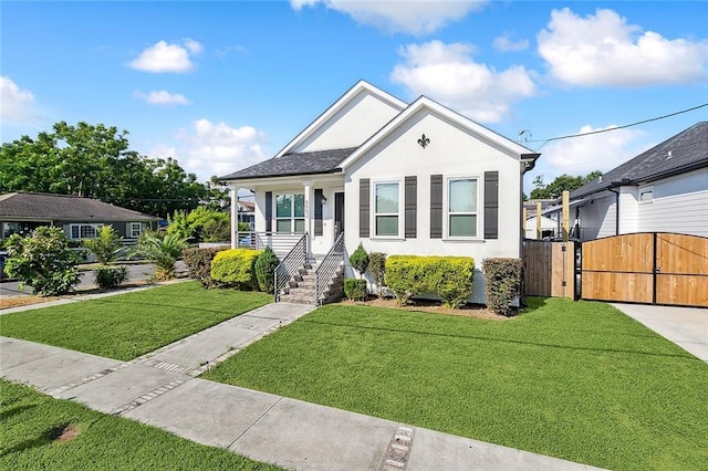 5502 Wilton Dr, New Orleans, LA 70122 - view of front of house with a gate and stucco siding