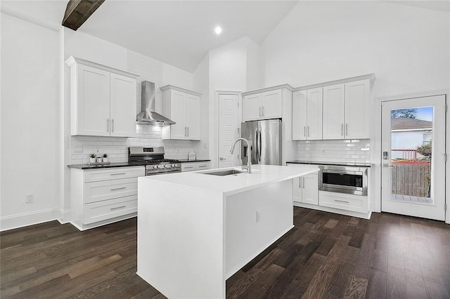 5502 Wilton Dr, New Orleans, LA 70122 - kitchen with wall chimney range hood, appliances with stainless steel finishes, high vaulted ceiling, backsplash, and dark wood finished floors