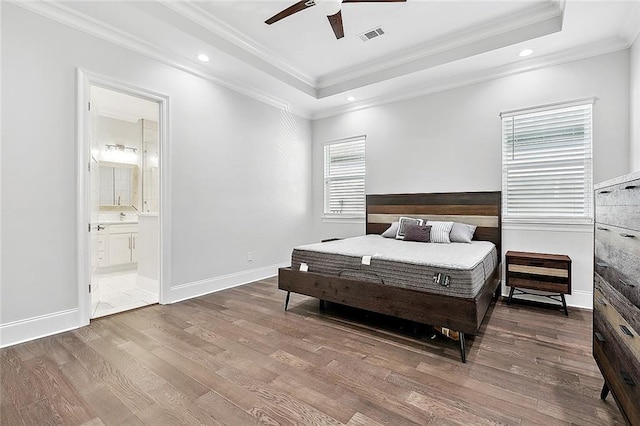5502 Wilton Dr, New Orleans, LA 70122 - bedroom featuring ornamental molding, wood finished floors, a tray ceiling, recessed lighting, and ensuite bath