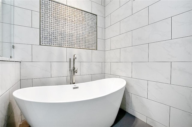 5502 Wilton Dr, New Orleans, LA 70122 - bathroom with tile walls and a freestanding bath
