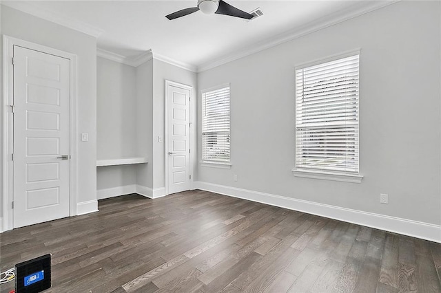 5502 Wilton Dr, New Orleans, LA 70122 - unfurnished bedroom featuring crown molding, dark wood-style flooring, ceiling fan, and a closet