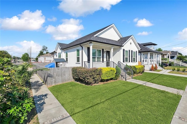 5502 Wilton Dr, New Orleans, LA 70122 - view of front facade with stucco siding, a shingled roof, and a residential view