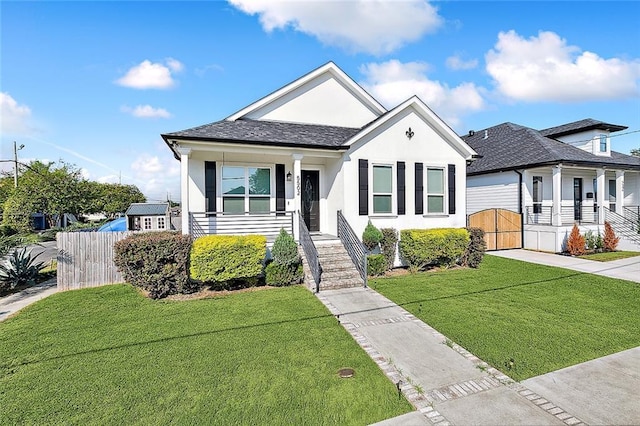 5502 Wilton Dr, New Orleans, LA 70122 - view of front of house with a porch, stucco siding, a gate, and stairway