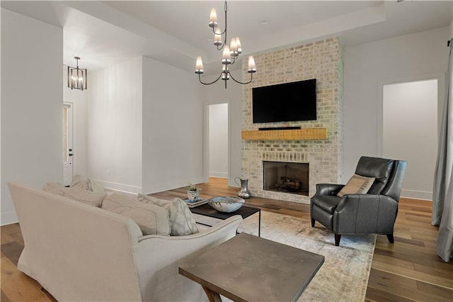 4028 Cypress Point Dr, Covington, LA 70433 - living room with a chandelier, wood finished floors, and a fireplace