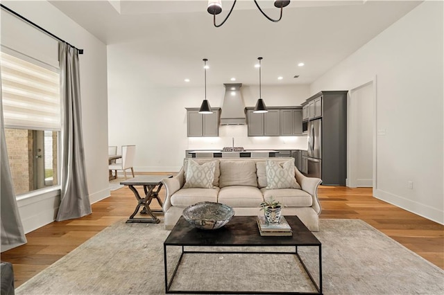 4028 Cypress Point Dr, Covington, LA 70433 - living room featuring light wood-style floors, recessed lighting, and a chandelier