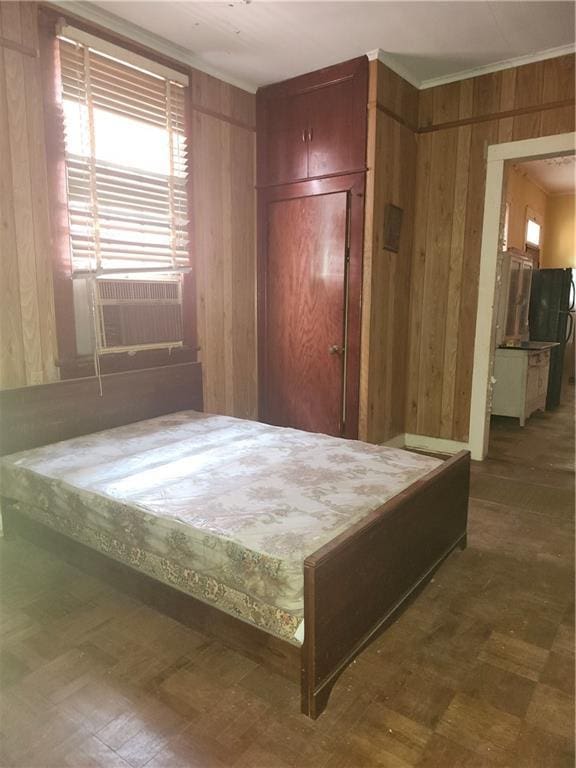 727 Montegut St, New Orleans, LA 70117 - bedroom with wood walls, cooling unit, and crown molding