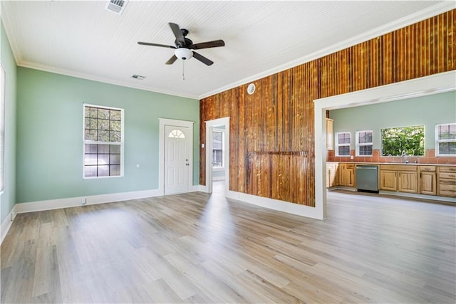 2970 College St, Slidell, LA 70458 - unfurnished living room featuring ceiling fan, crown molding, light wood-type flooring, and wooden walls