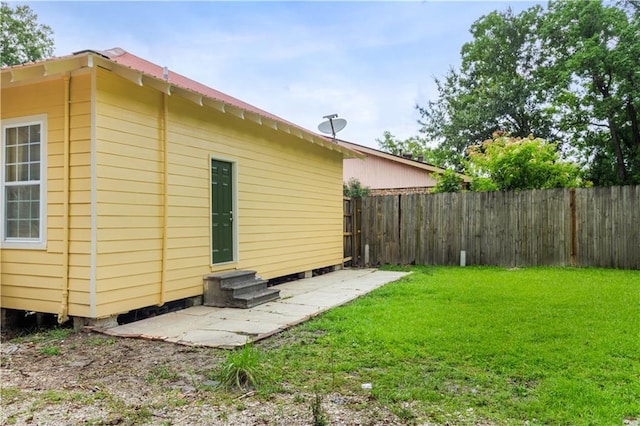 2970 College St, Slidell, LA 70458 - view of side of property featuring entry steps, a fenced backyard, a patio, and a metal roof