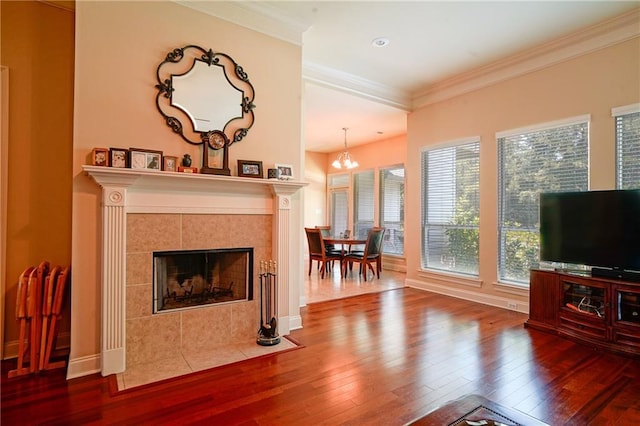 626 Bellingrath Ln, Slidell, LA 70458 - living room featuring hardwood / wood-style flooring, a tiled fireplace, a chandelier, crown molding, and recessed lighting