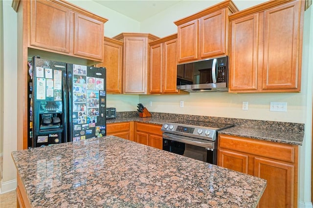 626 Bellingrath Ln, Slidell, LA 70458 - kitchen featuring black fridge with ice dispenser, stainless steel range with electric stovetop, and dark stone countertops