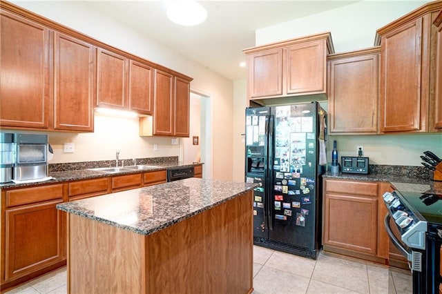 626 Bellingrath Ln, Slidell, LA 70458 - kitchen with black appliances, light tile patterned floors, dark stone countertops, and a center island