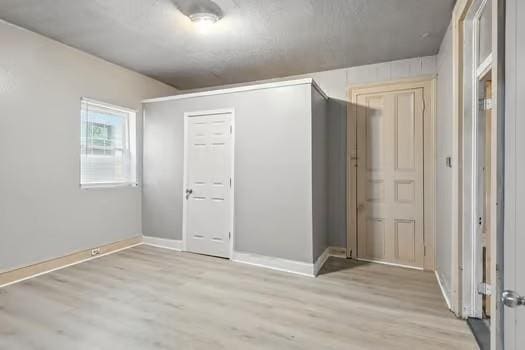 1635 Frenchmen St, New Orleans, LA 70116 - unfurnished bedroom featuring light wood-style floors and a closet
