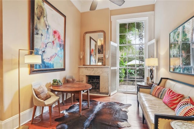 740 Esplanade Ave Unit 3, New Orleans, LA 70116 - living area featuring a high end fireplace, wood finished floors, and ceiling fan