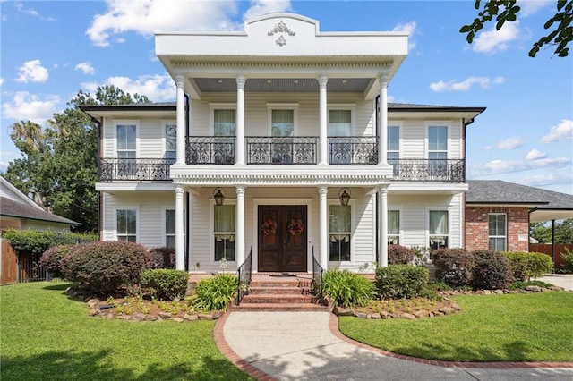 712 Stewart Ave, River Ridge, LA 70123 - greek revival inspired property featuring a balcony, french doors, covered porch, and a carport