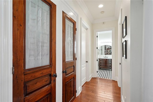 712 Stewart Ave, River Ridge, LA 70123 - corridor with hardwood / wood-style flooring and crown molding