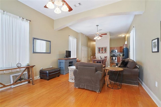 215 N Rendon St, New Orleans, LA 70119 - living area with a ceiling fan, light wood-style flooring, and beamed ceiling