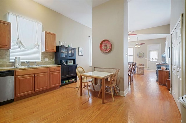 215 N Rendon St, New Orleans, LA 70119 - kitchen with dishwasher, ceiling fan, light wood-style floors, tasteful backsplash, and light countertops