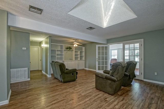 42 Hennessey Ct, River Ridge, LA 70123 - living room featuring wood finished floors, a textured ceiling, ceiling fan, and french doors