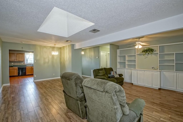 42 Hennessey Ct, River Ridge, LA 70123 - living area with a chandelier, wood finished floors, a textured ceiling, and ceiling fan