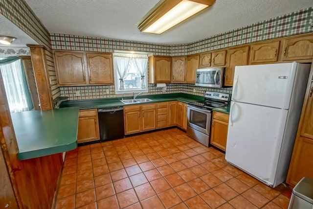 42 Hennessey Ct, River Ridge, LA 70123 - kitchen featuring stainless steel appliances, a textured ceiling, tasteful backsplash, wallpapered walls, and dark countertops