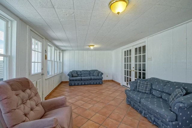42 Hennessey Ct, River Ridge, LA 70123 - living area with french doors, tile patterned flooring, and a decorative wall