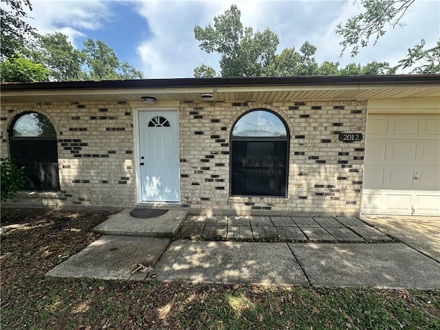 2012 S Sugar Ridge Rd, La Place, LA 70068 - doorway to property featuring brick siding and an attached garage