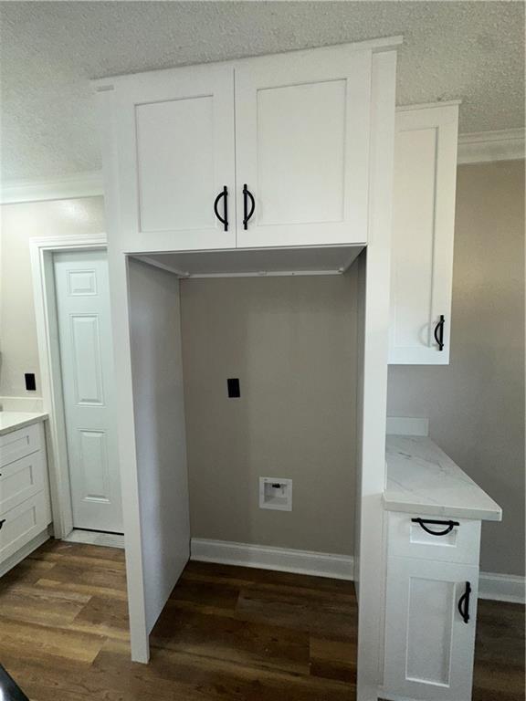2012 S Sugar Ridge Rd, La Place, LA 70068 - laundry room with crown molding, a textured ceiling, and dark wood finished floors