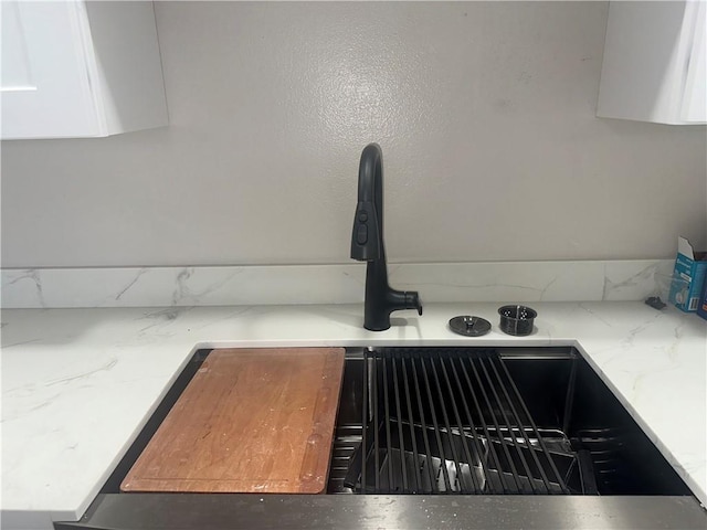 2012 S Sugar Ridge Rd, La Place, LA 70068 - kitchen view of white cabinets, light stone countertops, and tasteful backsplash