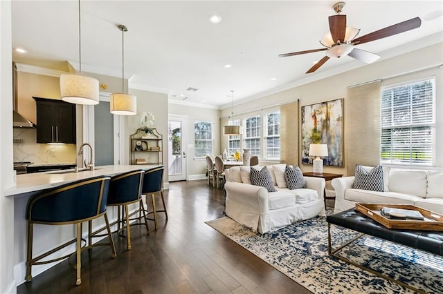 931 French St, New Orleans, LA 70124 - living area with dark wood-type flooring, crown molding, ceiling fan, and recessed lighting