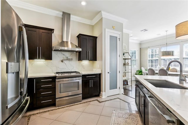 931 French St, New Orleans, LA 70124 - kitchen featuring appliances with stainless steel finishes, wall chimney range hood, tasteful backsplash, recessed lighting, and pendant lighting