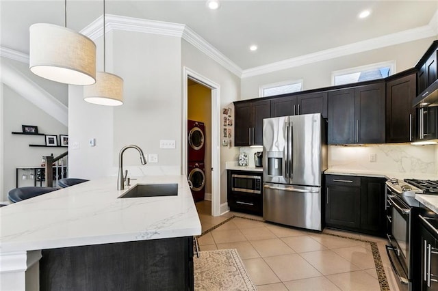 931 French St, New Orleans, LA 70124 - kitchen with stainless steel appliances, stacked washer / dryer, light tile patterned flooring, light stone counters, and decorative backsplash