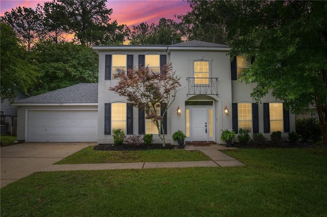 1125 Lori Dr, Slidell, LA 70461 - view of front of house with stucco siding, a garage, concrete driveway, a front lawn, and roof with shingles