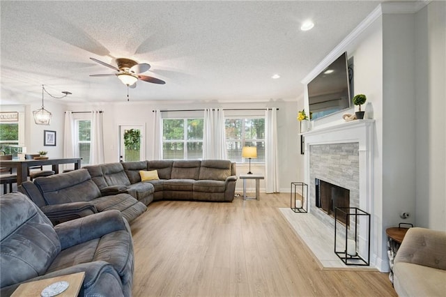 1125 Lori Dr, Slidell, LA 70461 - living area with light wood-style flooring, healthy amount of natural light, a ceiling fan, a textured ceiling, and crown molding