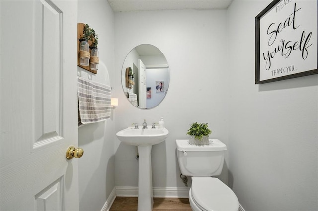 1125 Lori Dr, Slidell, LA 70461 - half bathroom featuring toilet and wood finished floors