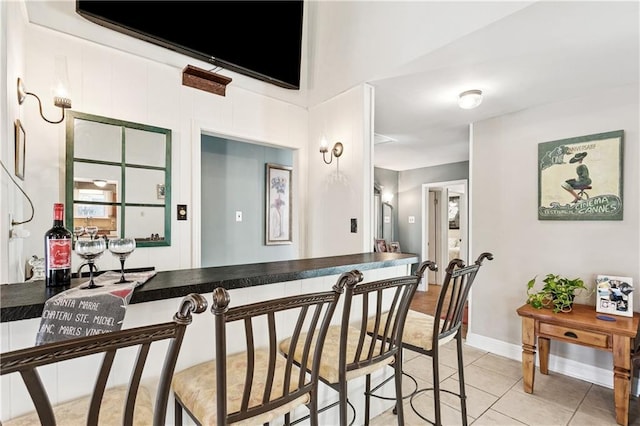 425 Eden Isles Blvd, Slidell, LA 70458 - dining space with light tile patterned floors and bar
