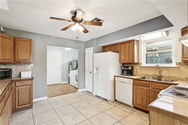 425 Eden Isles Blvd, Slidell, LA 70458 - kitchen with white appliances, backsplash, a ceiling fan, light countertops, and light tile patterned floors